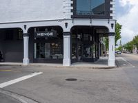 a small business in a city on the street corner with signs on it that read,'heritage henge '