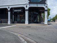 a small business in a city on the street corner with signs on it that read,'heritage henge '