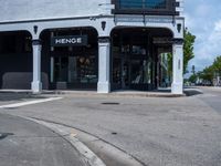 a small business in a city on the street corner with signs on it that read,'heritage henge '