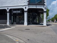 a small business in a city on the street corner with signs on it that read,'heritage henge '