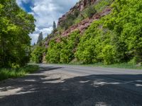 the red rocks are high up on the side of the road and it is an amazing color