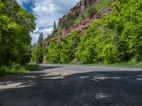 the red rocks are high up on the side of the road and it is an amazing color