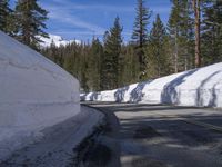 a white wall with some snow on it and a road that is half closed off