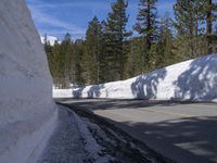 a white wall with some snow on it and a road that is half closed off