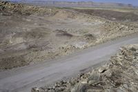 an image of a road through a valley in the desert with an open space for vehicles