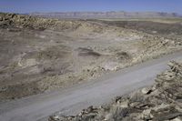 an image of a road through a valley in the desert with an open space for vehicles