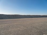 Road through Holland's Coastal Landscape with Clear Sky