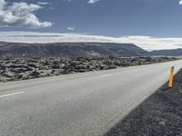 Road through the Icelandic Highland landscape with mountains and grass