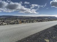 Road through the Icelandic Highland landscape with mountains and grass