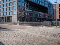 the large building is made of concrete and has metal railings around it, which are made of brick