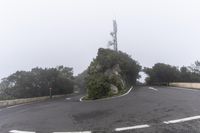 a road with a corner on a foggy day with no cars driving or standing