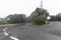 a road with a corner on a foggy day with no cars driving or standing