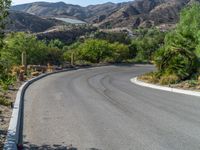 a street view with the mountains in the distance and a road in front of it