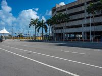 an empty lot with an empty parking lot in the background and clouds in the distance