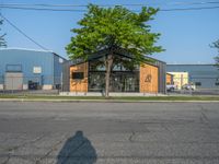 a yellow fire hydrant next to a fence and building with a large number 22 on it