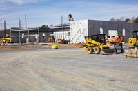 a group of construction workers working on construction site on sunny day on a construction site