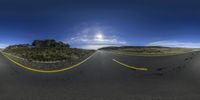 the road that goes from an empty desert to a beautiful blue sky in the sun