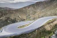 Road Through New Zealand Highland Landscape with Mountains and Grass