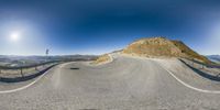 an image of a road going through the mountains in a 360 - lens style as seen from a fish eye point perspective