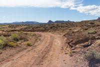 a small dirt path winds through the desert near a mountain peak in arizona's southwest