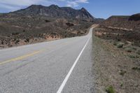 a bike is shown on a highway near the desert mountains of texas, usa by an unknown road