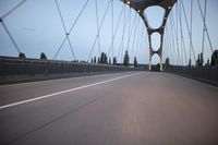 a view from behind of a moving car on the bridge in a city at dusk