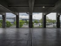 an empty parking garage with open doors on the side and a wire fence in front