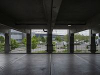 an empty parking garage with open doors on the side and a wire fence in front