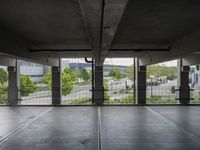 an empty parking garage with open doors on the side and a wire fence in front