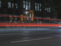 people are gathered in the dark to watch a biker in a bike lane at night