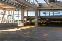 the concrete floor of a parking lot with two buildings and large windows on one side and some bright yellow striped line