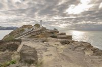 Rocky Cliff Over Ocean with Gloomy Grey Sky