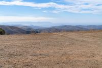 the hills in the distance are rocky and empty, and there is no one on the far side