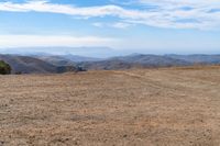 the hills in the distance are rocky and empty, and there is no one on the far side