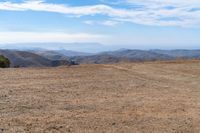 the hills in the distance are rocky and empty, and there is no one on the far side