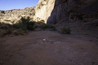 view down an open rocky riverbed near cliffs, with a frisbee on the ground