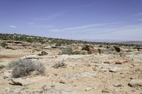 the view from above an area that contains rocky terrain and mountains with sparse shrubs, shrubs and rocks