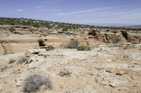 the view from above an area that contains rocky terrain and mountains with sparse shrubs, shrubs and rocks