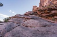 a person walking up and down a rock face side by side on a rocky trail