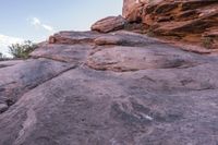 a person walking up and down a rock face side by side on a rocky trail