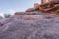 a person walking up and down a rock face side by side on a rocky trail