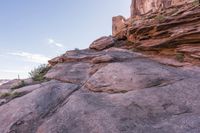 a person walking up and down a rock face side by side on a rocky trail