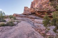 a person walking up and down a rock face side by side on a rocky trail