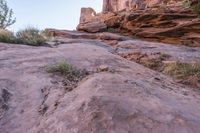 a person walking up and down a rock face side by side on a rocky trail