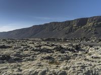 an image of a mountain landscape with rocks and gravels on the ground on a sunny day