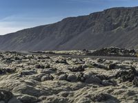 an image of a mountain landscape with rocks and gravels on the ground on a sunny day