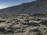 an image of a mountain landscape with rocks and gravels on the ground on a sunny day