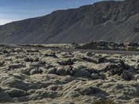 an image of a mountain landscape with rocks and gravels on the ground on a sunny day