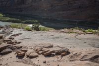 the large, red rock formation features boulders that look like animals and plants surrounding a shallow river