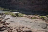 the large, red rock formation features boulders that look like animals and plants surrounding a shallow river